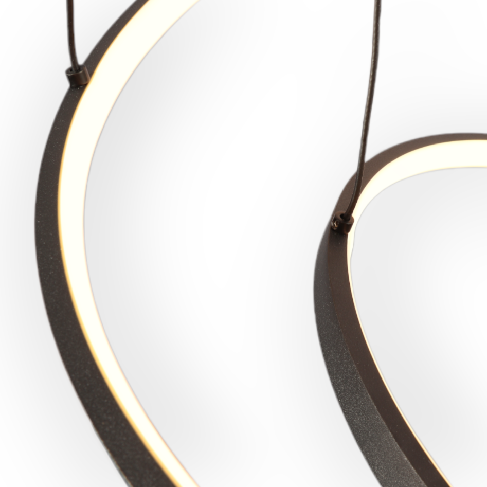 Image showcasing the Astral Trinity Chandelier with its sleek, modern design, featuring three interconnected circles elegantly suspended, casting a soothing 3000K glow in a contemporary interior setting.