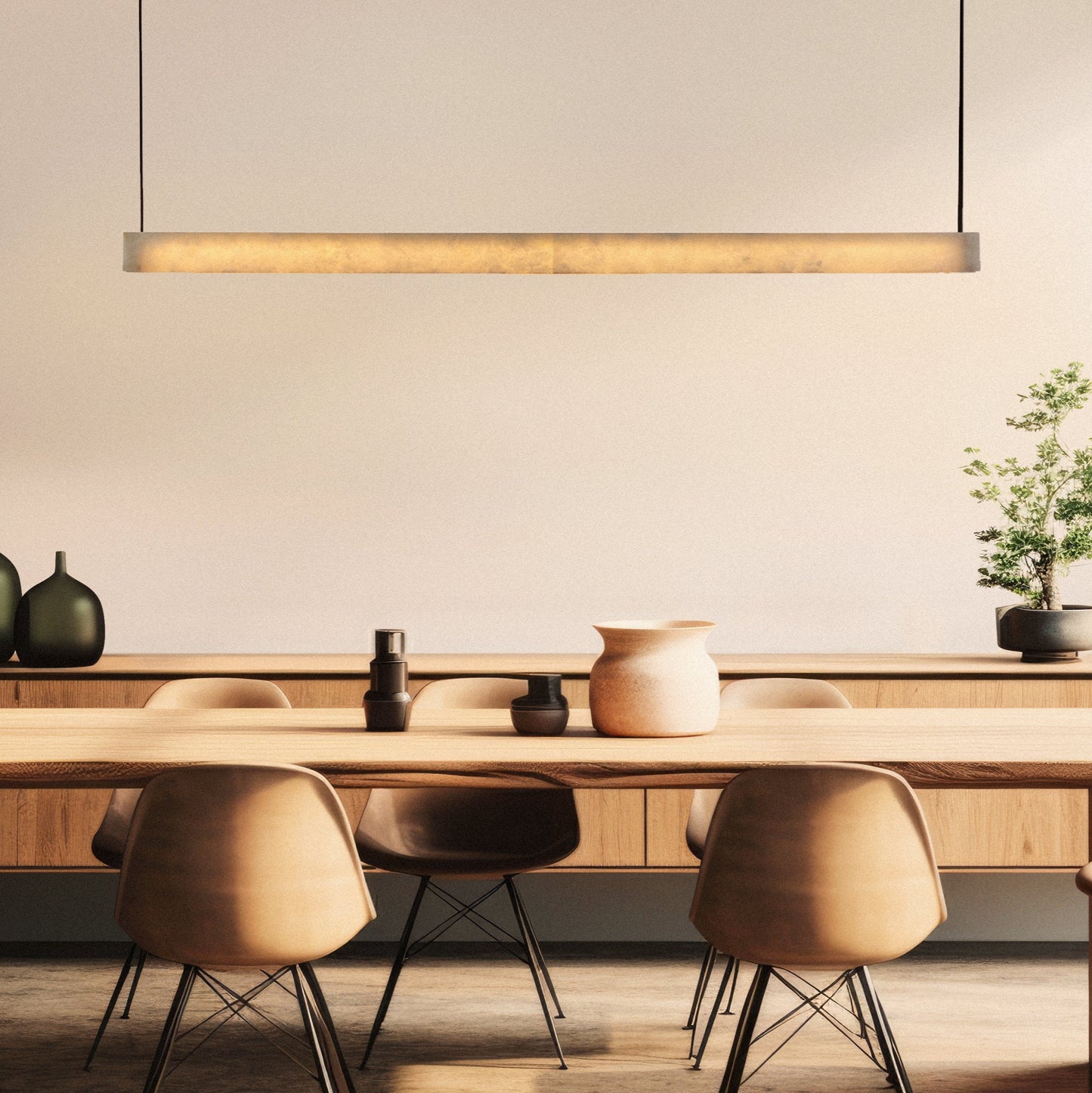 The images display the Slate Linear Pendant, showcasing a sleek, minimalist design. The fixture features a slender PU bar that houses alabaster elements, emanating a warm and soft glow that beautifully diffuses through the stone.