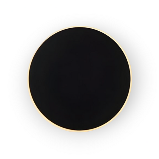 This image captures the Amos Wall Light, distinguished by its circular shape with a matte black finish, encircled by a subtle gold trim. This elegant wall-mounted fixture offers a sophisticated, understated design that provides ambient lighting with a contemporary flair.