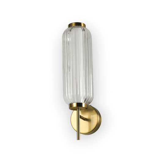 Featured is the Arden Wall Light, showcasing an elegant vertical ribbed glass shade affixed to a brass fixture. The wall light exudes a classic charm with its soft, diffused light, perfect for creating a warm, inviting atmosphere in any traditional or contemporary interior.