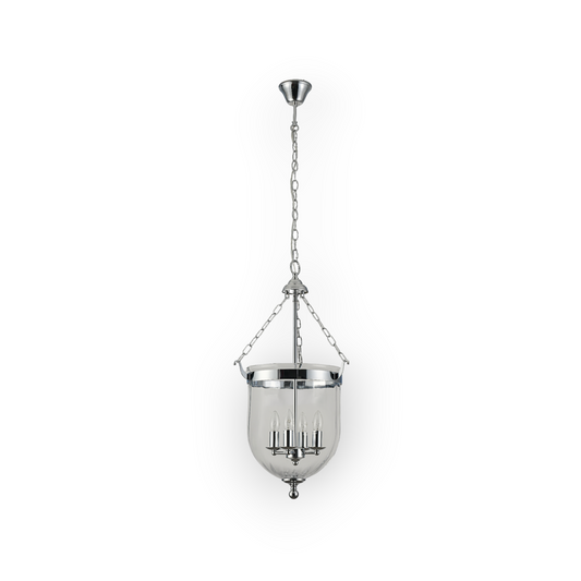 The image shows the Cape 4L Pendant, featuring a traditional bell-shaped glass enclosure suspended by a chain, with polished nickel accents and four candelabra-style lights within. This classic design merges old-world charm with contemporary craftsmanship.