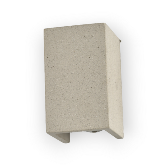 This image showcases the Capri Wall Light, an exquisite fixture designed with a robust, textured concrete body that emanates a soft, warm glow from its open bottom. The earthy, natural finish complements its minimalist cube design, making it an ideal choice for enhancing the ambiance of modern, eco-friendly interiors.