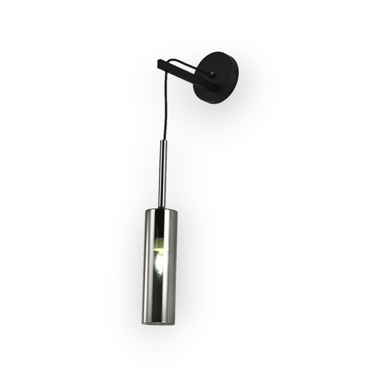 The image presents a sleek and modern wall-mounted light fixture featuring a minimalist design. The light has a cylindrical body with a dark finish, attached to a matching rounded wall mount via a slim, angular arm. A single bulb is visible at the lower end of the cylinder, illuminating downwards to create a focused beam of light. This fixture combines functionality with a contemporary aesthetic, making it ideal for modern interior spaces that emphasize clean lines and simple forms.