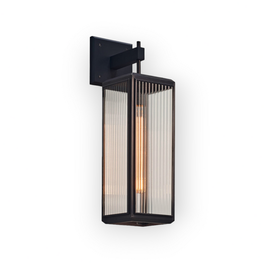 Featuring the Levi Wall Light, this image captures the industrial-chic essence with its bold black frame and fluted glass panels. The filament bulb within adds a vintage touch, ideal for loft-style interiors and modern homes seeking a statement piece.