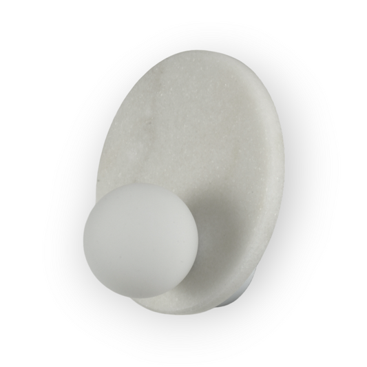 This image features the Mira Wall Light, a stunning piece with a white marble-patterned plate encircling a frosted glass sphere. The design marries natural stone textures with contemporary lighting for an elegant and striking visual effect.