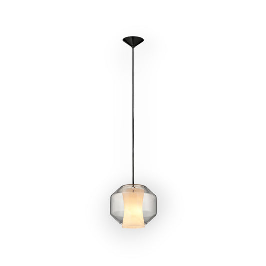 This image highlights the Rivo 1L Pendant, displaying a geometric glass shade that subtly reveals a warm, inner glow. The central band’s gradient gives the piece a touch of modernity, perfect for spaces seeking minimalistic charm with a warm ambiance.